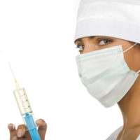 nurse in mask holding syringe
